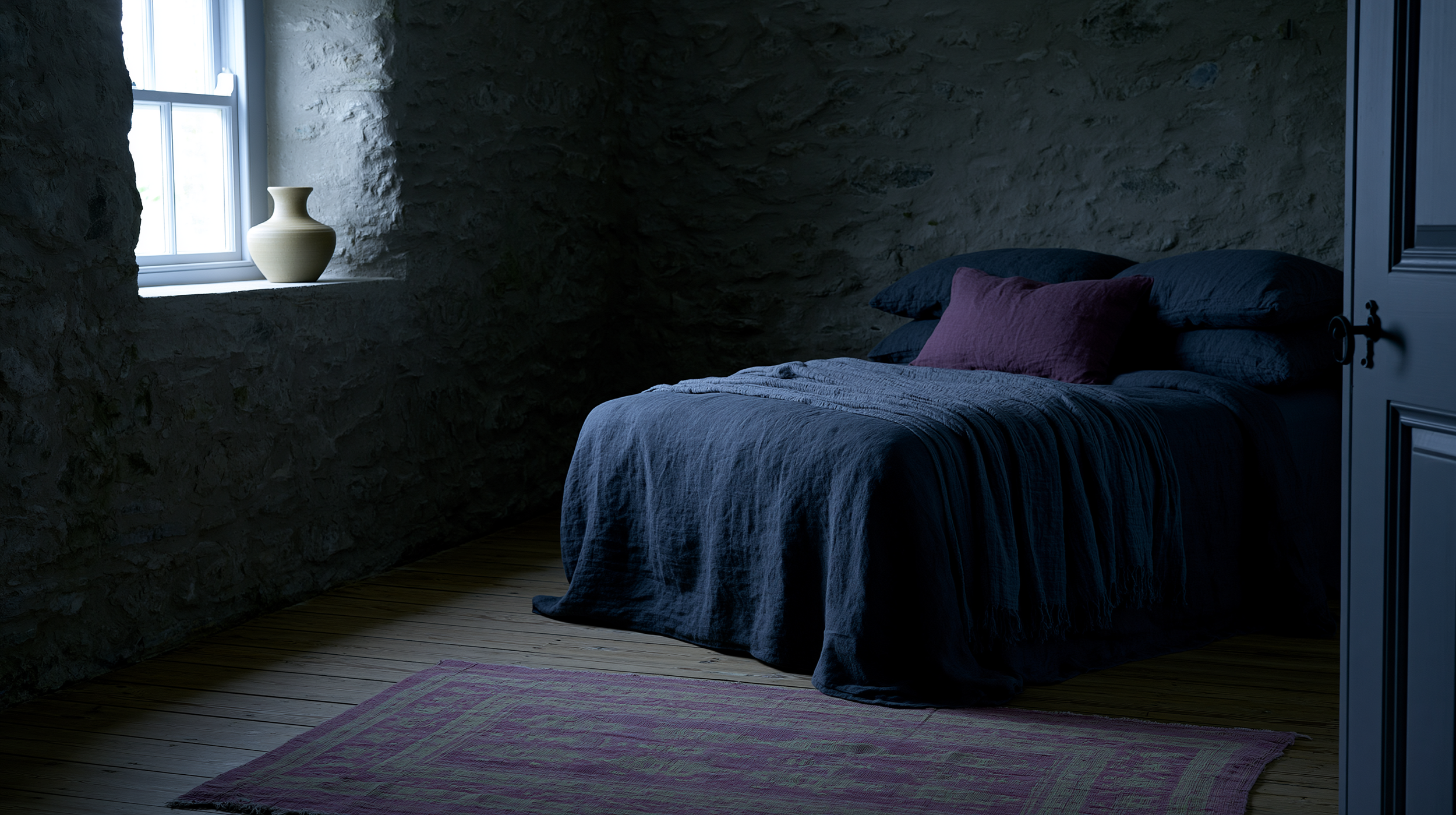 Dark cottagecore bedroom with blue linen bedding and soft window light